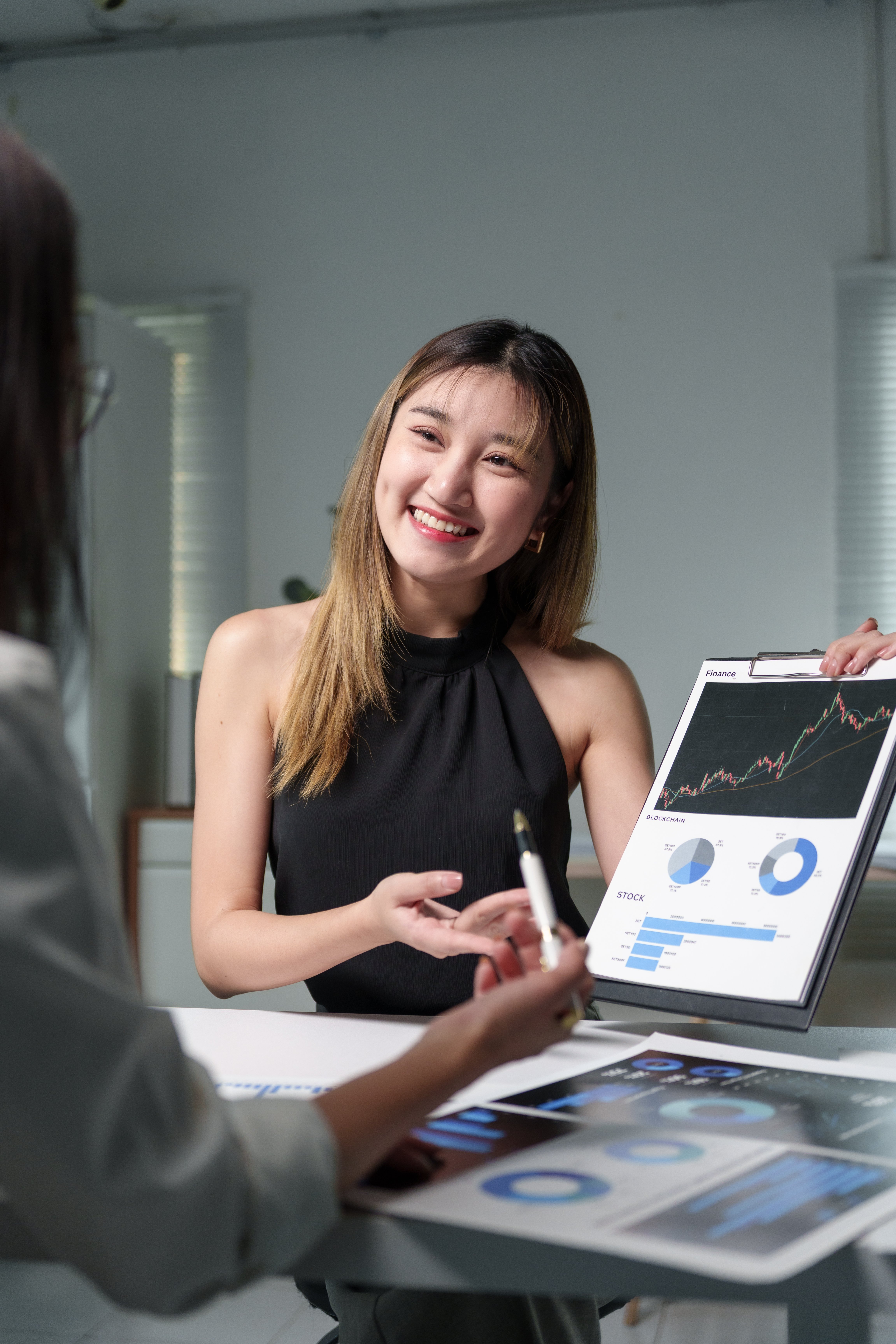 businesswomen-discussing-financial-charts-and-grap-2025-10-08-13-02-03-utc